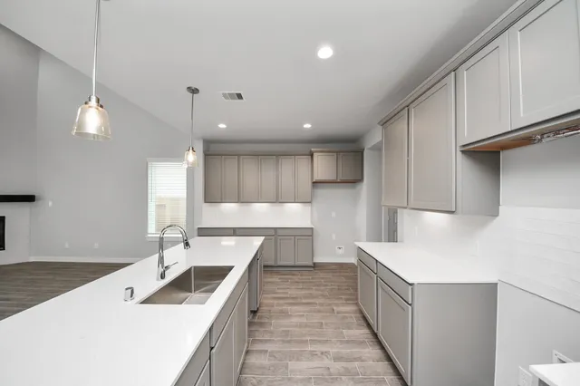 a kitchen with counter top space a sink stainless steel appliances and cabinets