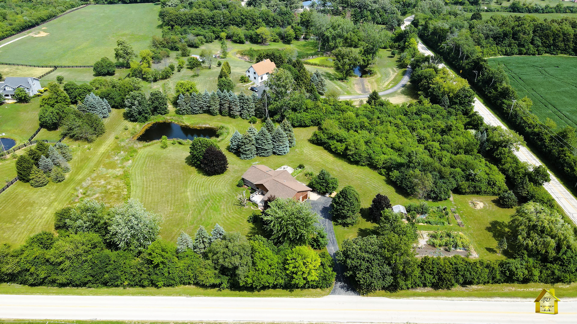 6514 Hamilton Road Huntley, IL 60142 - Photo 18 of 40 a view of a garden with a tree