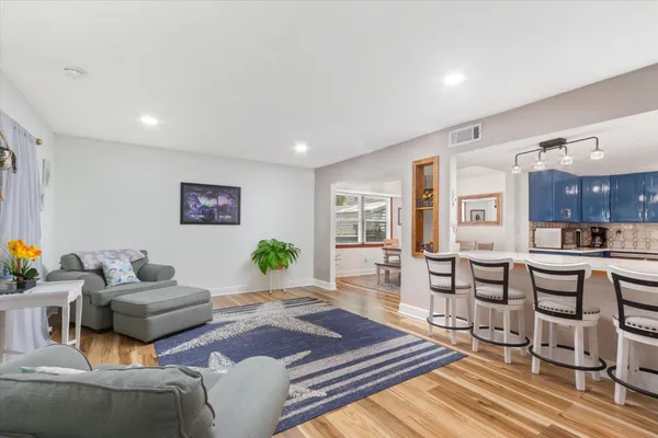 a living room with furniture and wooden floor