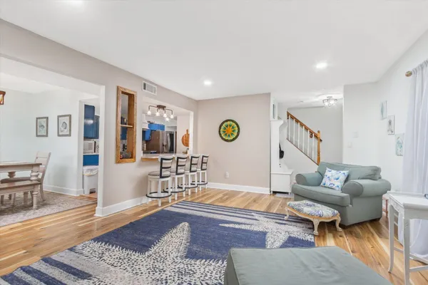 a living room with furniture and wooden floor