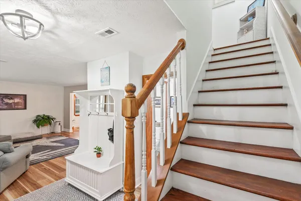 a view of entryway with furniture and wooden floor