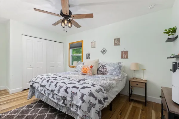 a bedroom with a bed and a chandelier