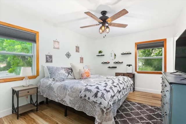 a bedroom with a bed and a window