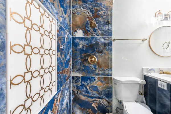 a bathroom with a toilet and a shower curtain