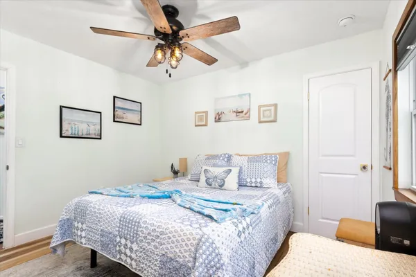 a bedroom with a bed and wooden floor