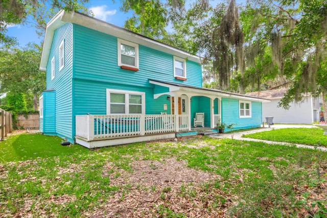 a street view with a fence and trees