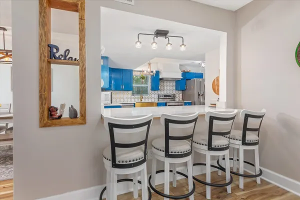 a room with a dining table and chairs