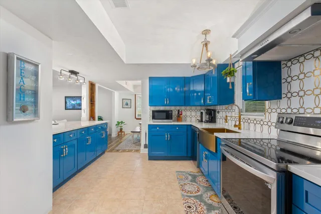 a kitchen with stainless steel appliances granite countertop a stove sink and cabinets