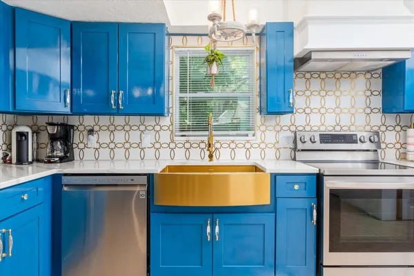 a kitchen with a sink cabinets and window