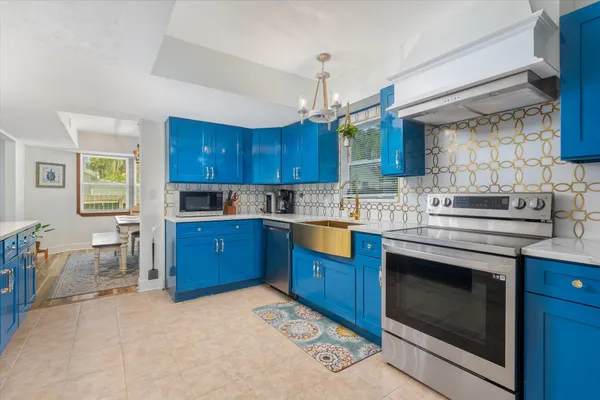 a kitchen with a sink stove and wooden cabinets