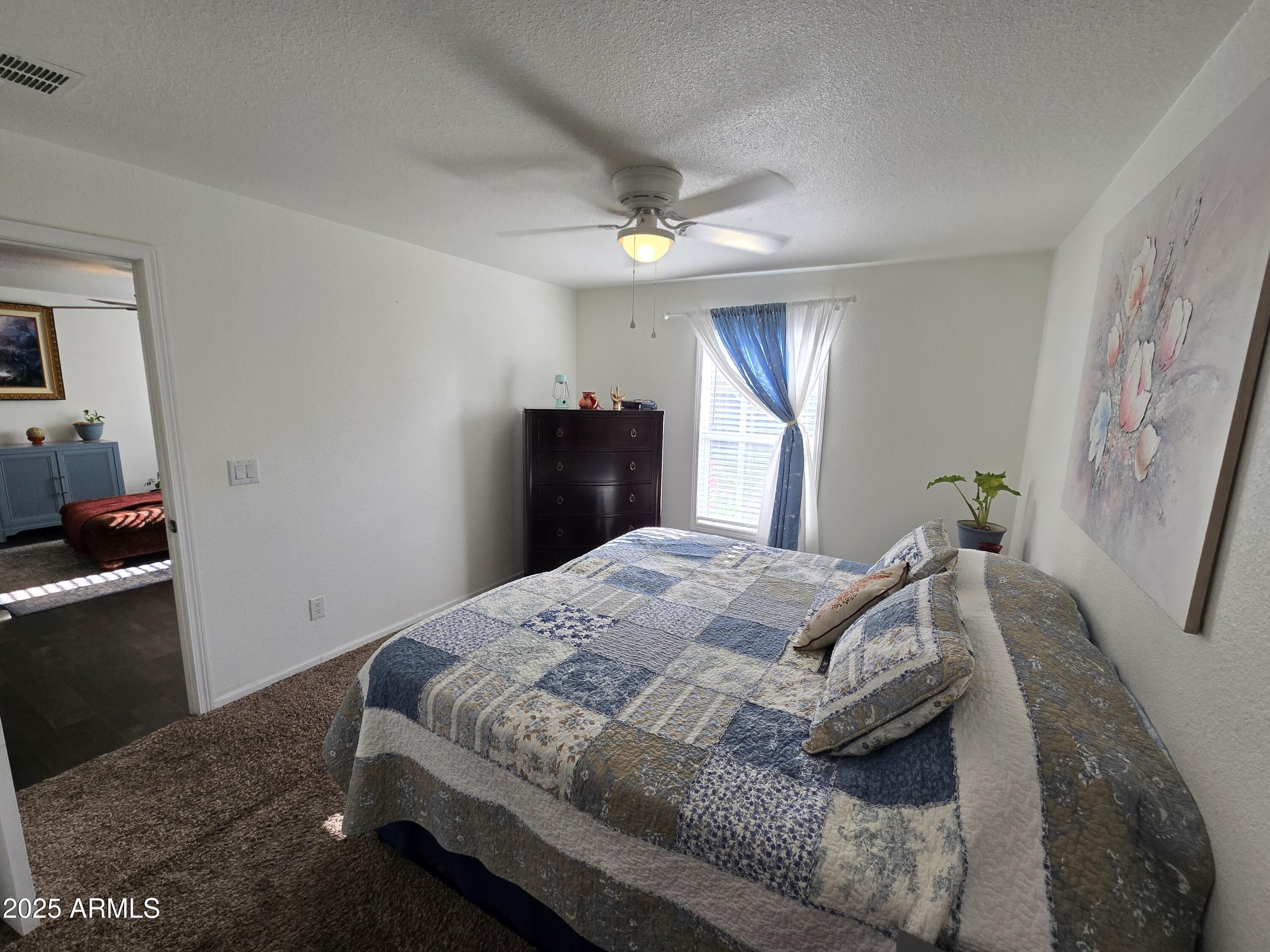 2000 South Apache Road, Unit 277 Buckeye, AZ 85326 - Photo 4 of 13 a bedroom with a bed and a closet