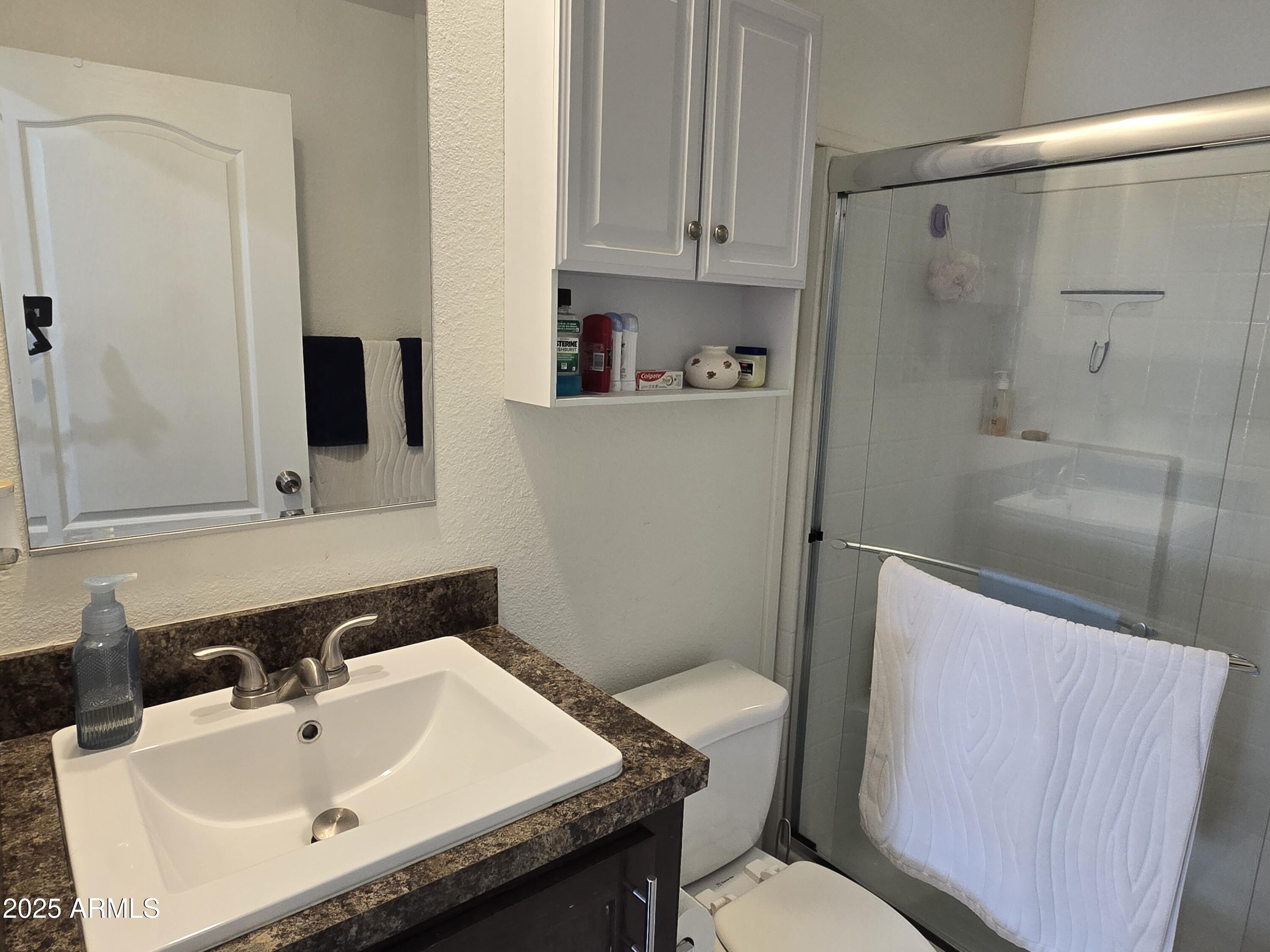 2000 South Apache Road, Unit 277 Buckeye, AZ 85326 - Photo 5 of 13 a bathroom with a sink a toilet and shower
