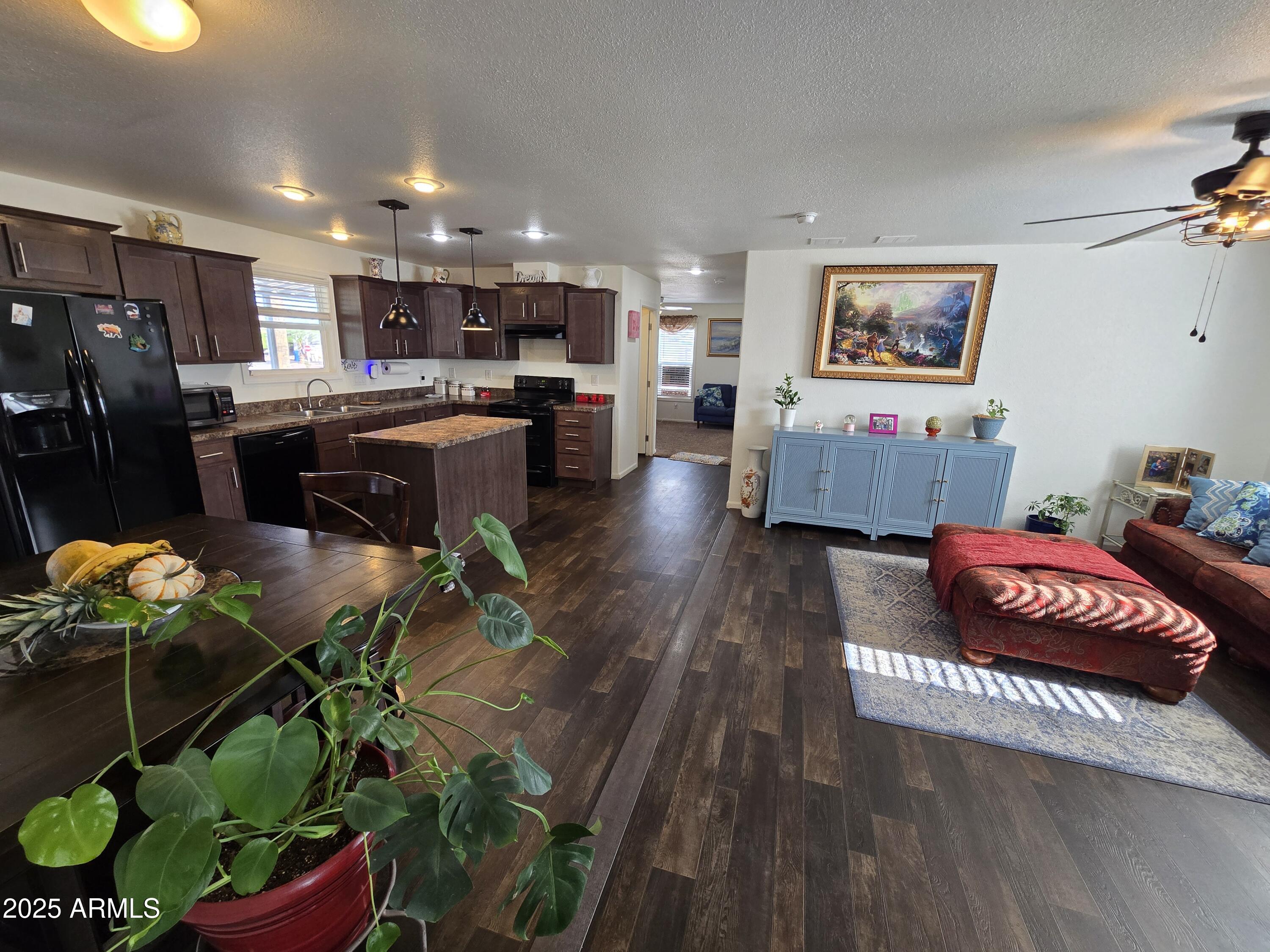 2000 South Apache Road, Unit 277 Buckeye, AZ 85326 - Photo 6 of 13 a living room with furniture and a potted plant