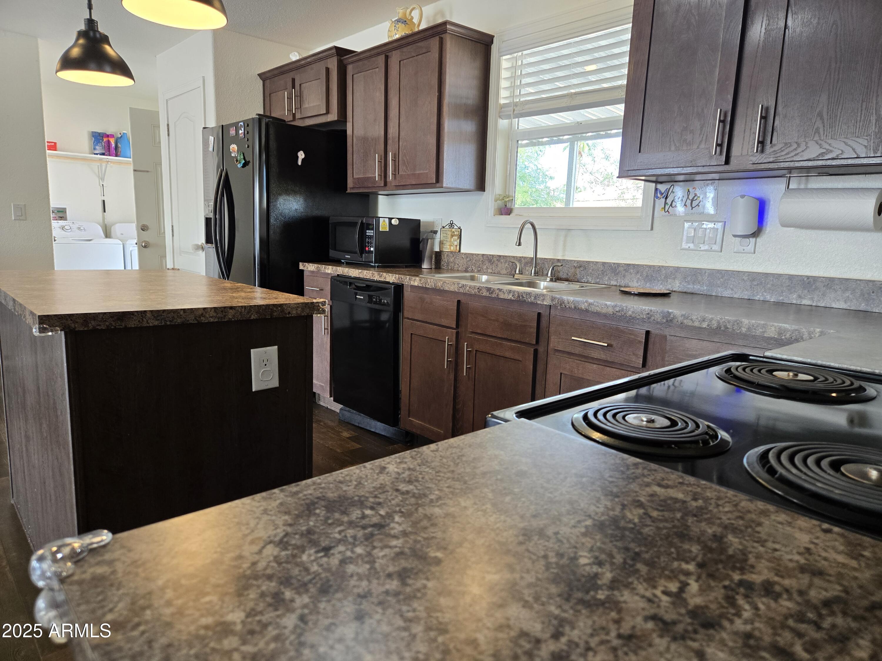 2000 South Apache Road, Unit 277 Buckeye, AZ 85326 - Photo 8 of 13 a kitchen with a stove a refrigerator and a sink