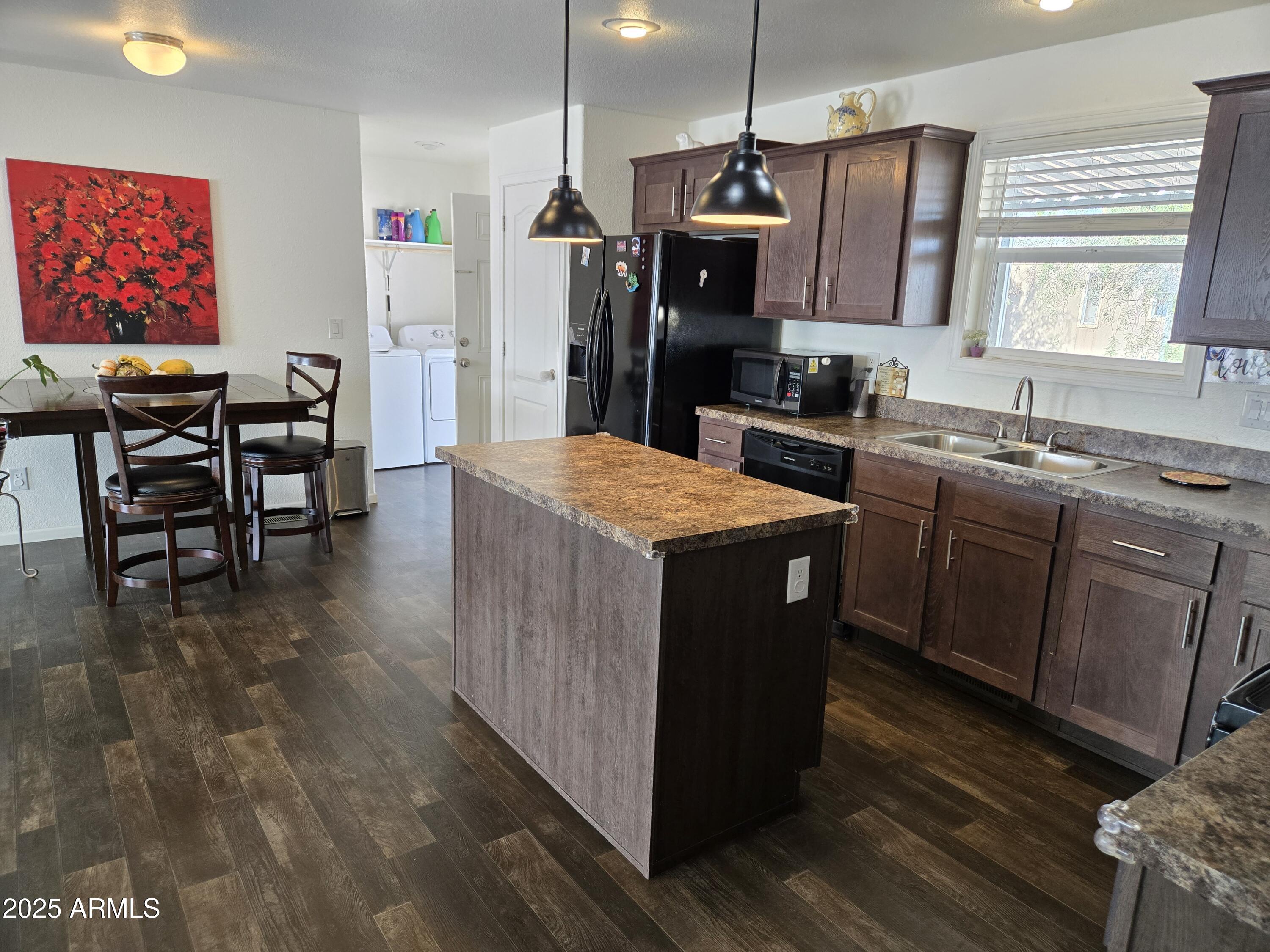 2000 South Apache Road, Unit 277 Buckeye, AZ 85326 - Photo 9 of 13 a kitchen with stainless steel appliances granite countertop a stove a sink dishwasher and a refrigerator with wooden floor