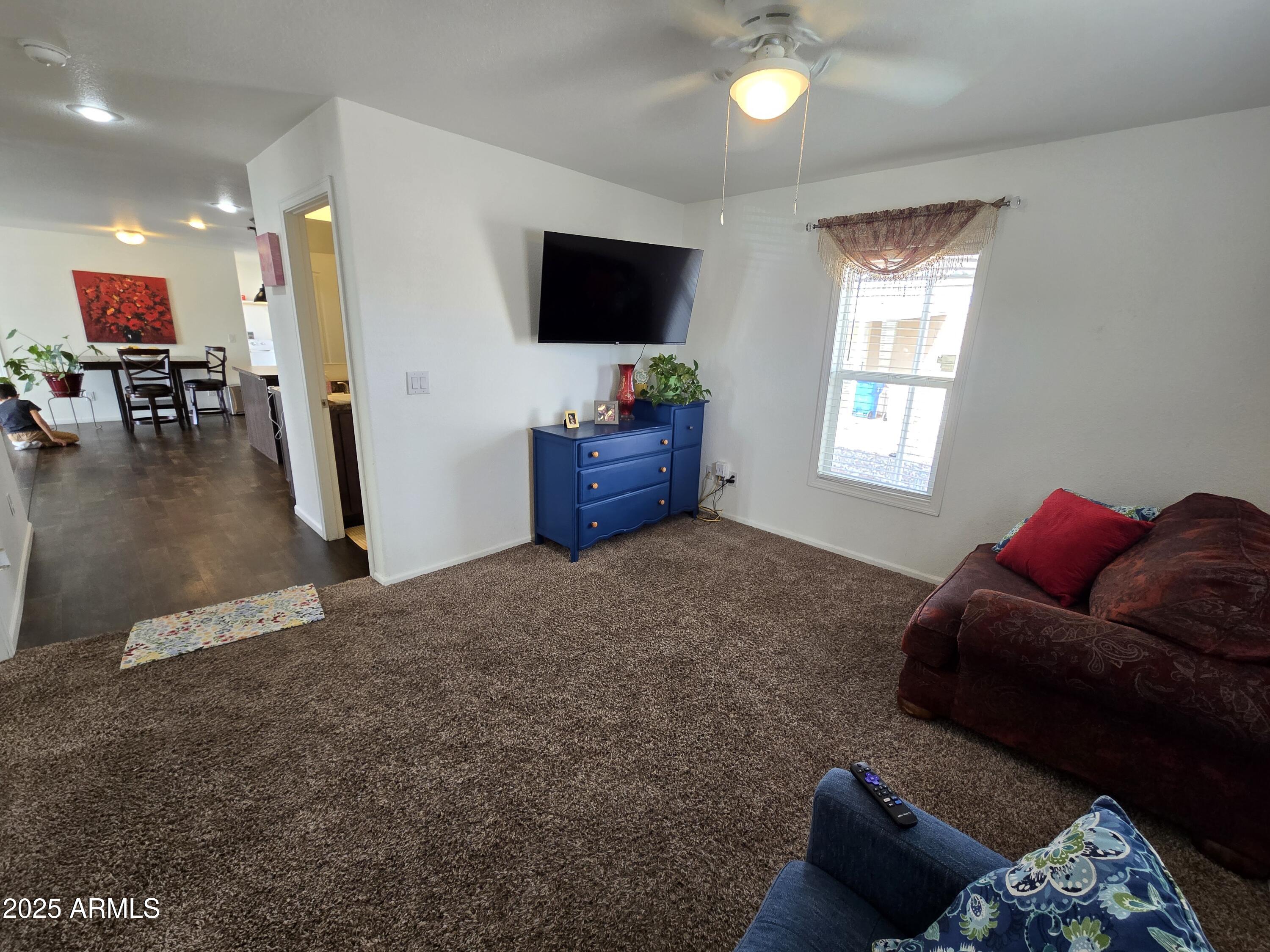 2000 South Apache Road, Unit 277 Buckeye, AZ 85326 - Photo 10 of 13 a living room with furniture and a flat screen tv