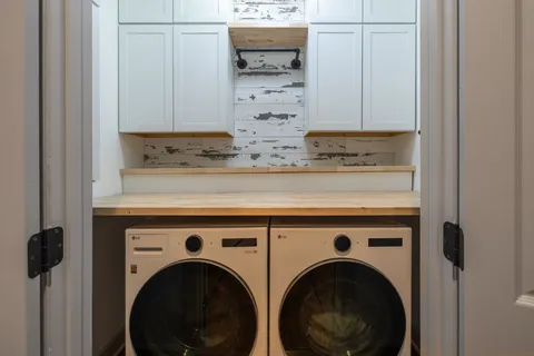 a view of washer and dryer with kitchen in the background
