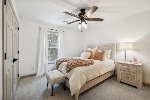 a bedroom with a bed and a chandelier