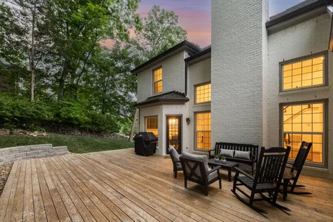 a view of a house with backyard porch and sitting area