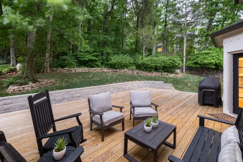 a view of a backyard with sitting area