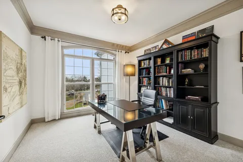 a workspace with furniture and a book shelf