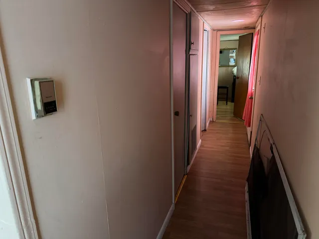 a view of a hallway with a wooden floor