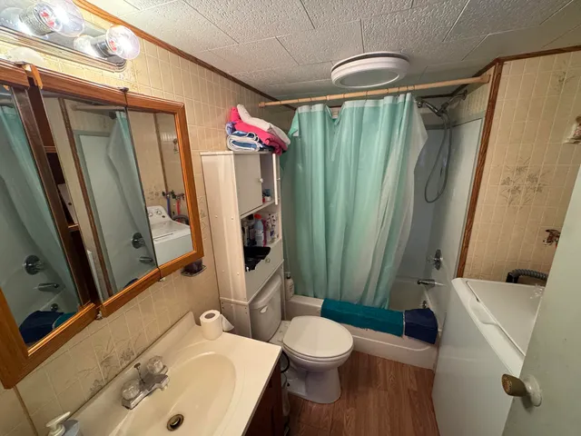 a bathroom with a sink toilet and shower