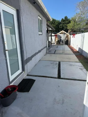 a view of a balcony with two chairs and a potted plant