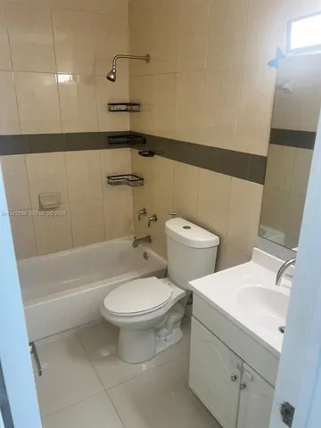 a bathroom with a toilet a sink and bathtub