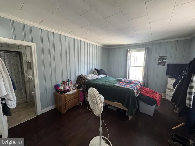 a bed room with a bed and a chair