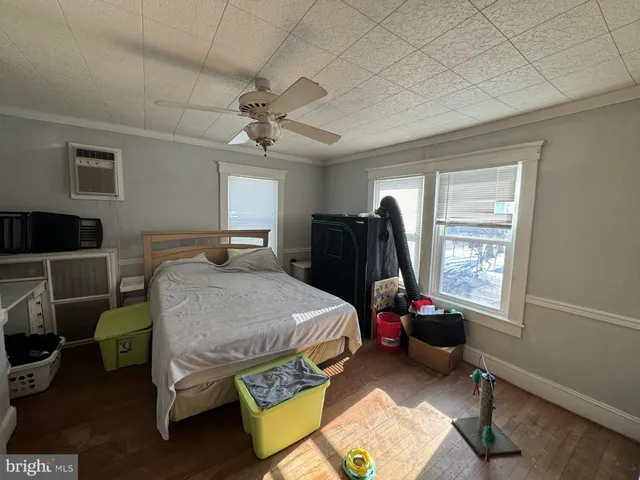 a bedroom with a bed closet and a window