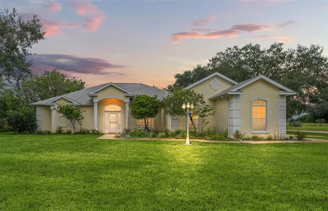 a front view of house with yard and green space