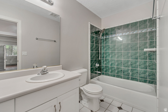 2154 Wasatch Boulevard Sandy, UT 84092 - Photo 39 of 55 Bathroom with shower combination, tile patterned floors, vanity, and a textured ceiling