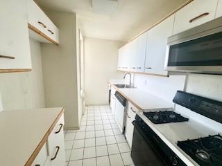 3855 Shore Parkway, Unit 3M Brooklyn, NY 11235 - Photo 11 of 11 a kitchen with a stove and a microwave