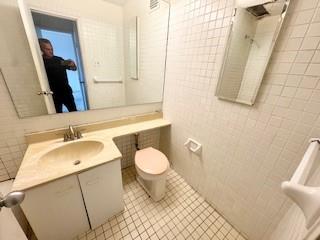 3855 Shore Parkway, Unit 3M Brooklyn, NY 11235 - Photo 7 of 11 a bathroom with a sink a toilet and a mirror