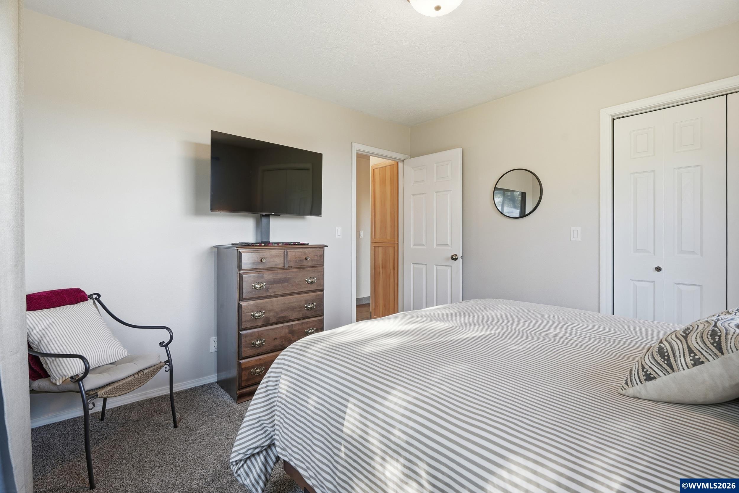 1110 Reuben Boise Road Dallas, OR 97338 - Photo 30 of 49 a bedroom with a bed and a flat screen tv