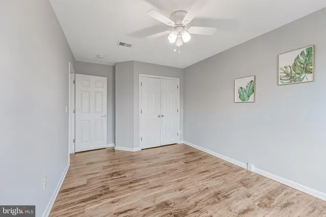 a view of a room with wooden floor