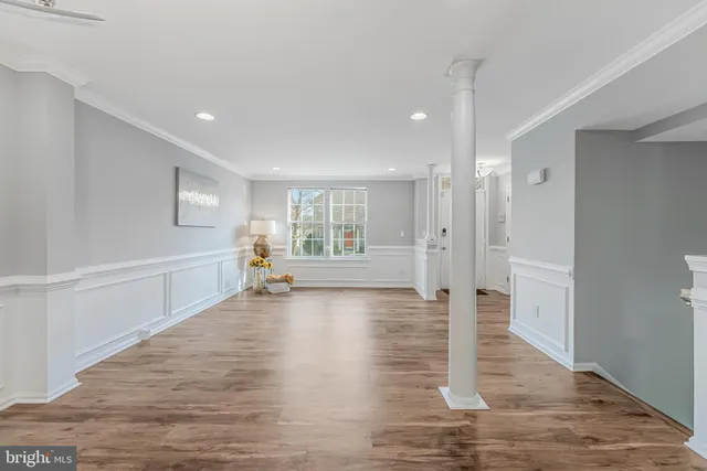 a kitchen with a refrigerator a sink and dishwasher with wooden floor
