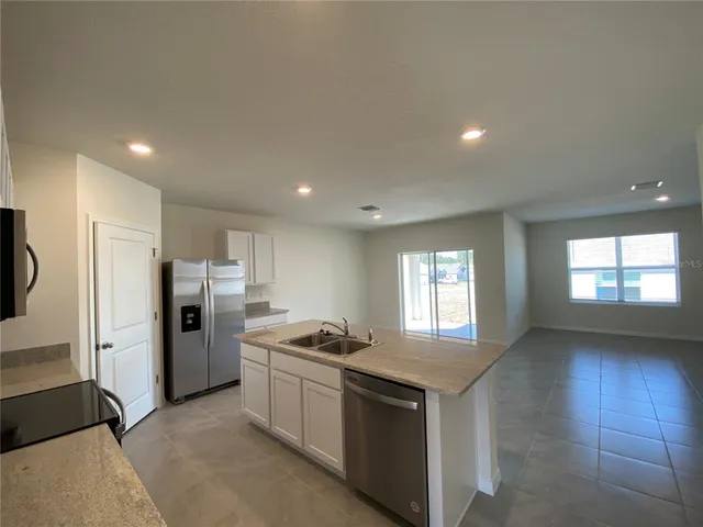 a kitchen with refrigerator and window
