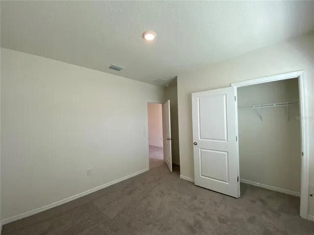 an empty room with closet area