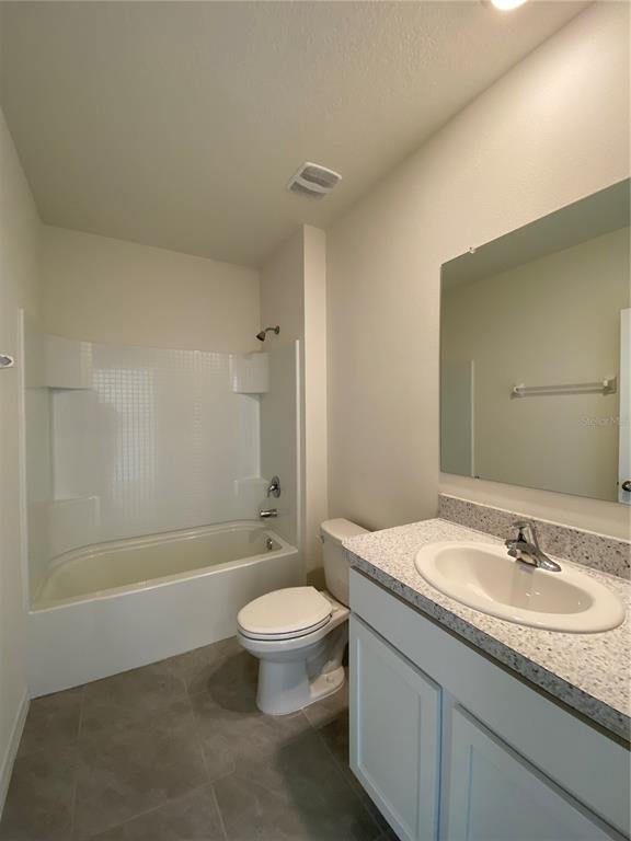 14 Hickory Course Lane Ocala, FL 34472 - Photo 10 of 20 a bathroom with a granite countertop sink a toilet and shower