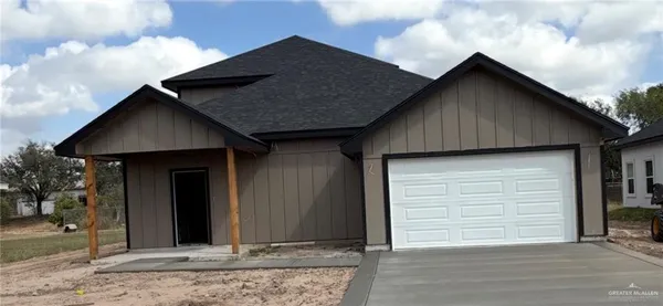 a view of house with backyard and parking space