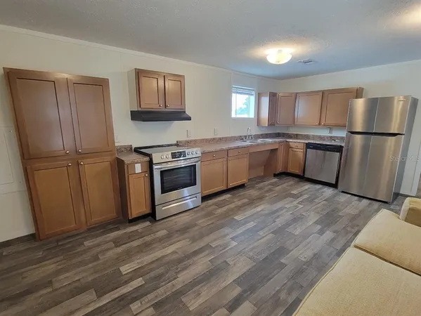 a kitchen with a refrigerator a sink a stove a microwave and island