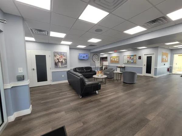 a living room with furniture and a kitchen