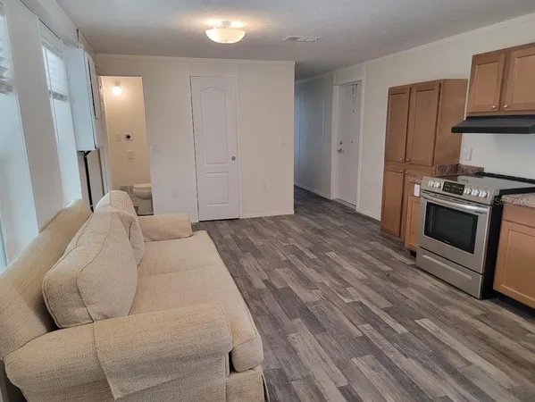 a bedroom with a bed and a television