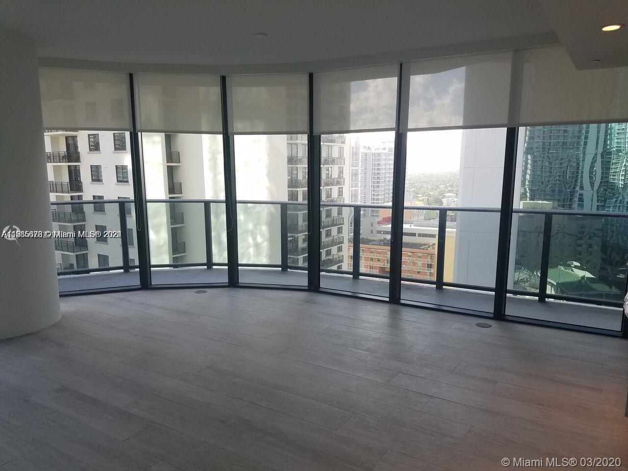 a view of an empty room with a floor to ceiling window