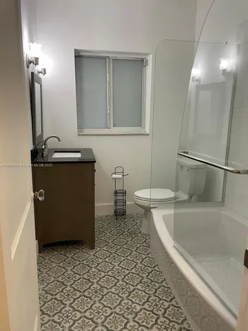 a bathroom with a bathtub sink and toilet