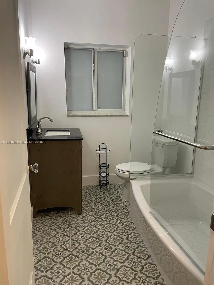 125 Southwest 32nd Court Road Miami, FL 33135 - Photo 4 of 5 a bathroom with a bathtub sink and toilet