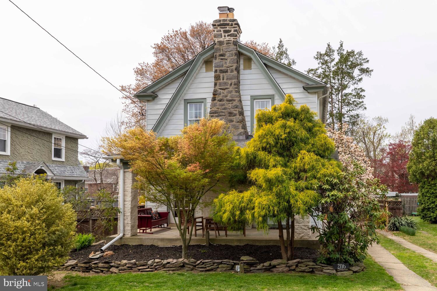 2116 East County Line Road Ardmore, PA 19003 - Photo 2 of 38 a front view of a house with a garden