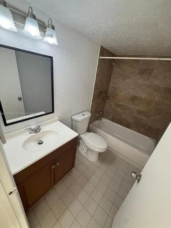 a bathroom with a sink mirror and toilet